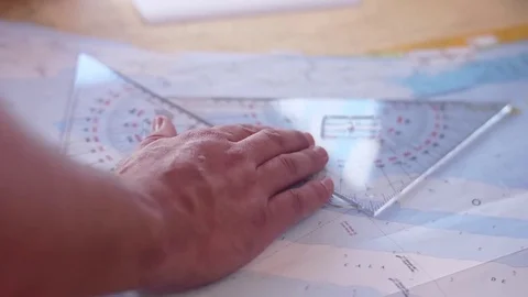 sailor reading nautical chart map - Sailor Reading Nautical Chart Map Footage 083260040 Iconl 