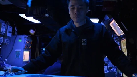 Sailor reading from navigation chart in control room aboard USS Mount Whitney 動画素材 110843526