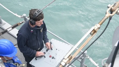 Sailor remotely controlling mine neutralization vehicle from console Stock Footage 86894080