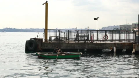 Sailor rowing his small boat to the harbor, 4K, DNxHR Stock-Footage 151071875