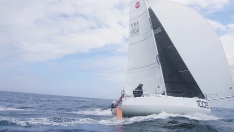 A sailor sails his boat on the ocean, in Brittany, France Stock Footage 229736995