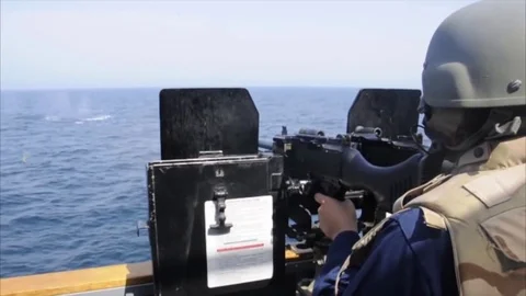 Sailor shoots with artillery mount Mark 38 Stock Footage 121027696