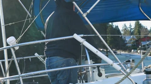 Sailor starting boat's engine, boat departing, rearing back Stock Footage 58681121