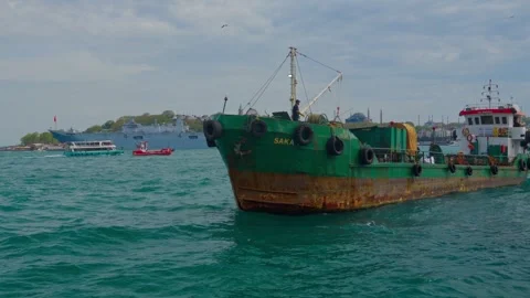 Sailor Throwing Rope to Dock a Green Ship in Istanbul Bosphorus Stock Footage 337530490