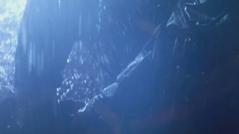 Sailor untangles wet rope on deck under heavy rain Stockbeeldmateriaal 321773873