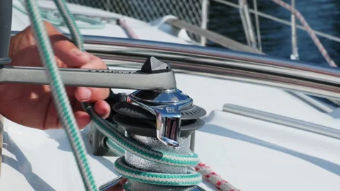 Sailor wraps rope around drum before using manual winch Stock Footage 264776061