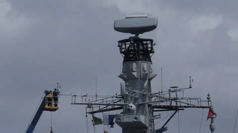 Sailord fixing wind air speed meter on warship mast Stock Footage 40358955