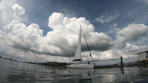 Sailors checking the sails of a boat docked in the marina, time-lapse video Stock Footage 166055832
