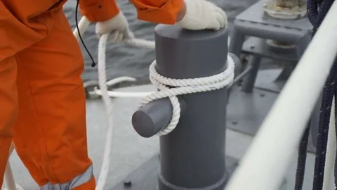 Sailor's hands pulling ropes of anchor Видео 73132787