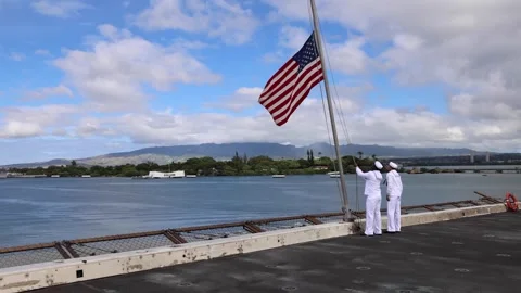 Sailors hoisting U.S. flag aboard USS Somerset (LPD 25) arriving in Pearl Harbor Stock Footage 278581179