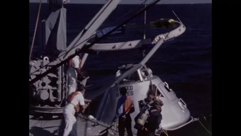 Sailors lowering Apollo 8 command module into sea with winch for egress training Stockbeeldmateriaal 271518897