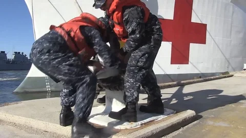 Sailors release mooring lines attached to the  USNS Comfort (TA-H 20) - 2015 Video stock 106008580