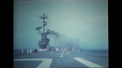 Sailors walking towards the camera on the flight deck of USS Wasp Stock Footage