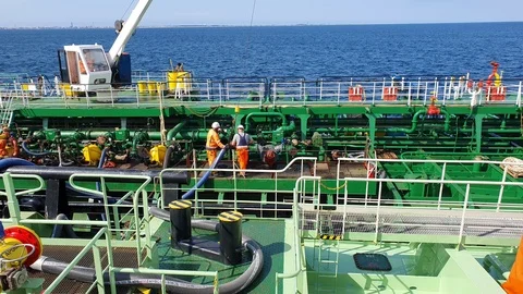Sailors work on deck and set bunker hoses distant view Stock Footage 121118225
