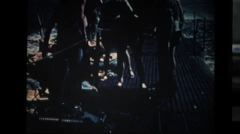 Sailors working with deflated lifeboat on deck of submarine Stock Footage