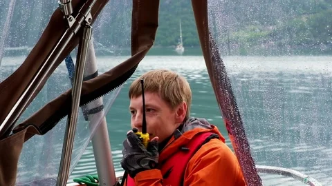 Sailsman in safe jackets talks on portable radio on yacht 스톡 동영상 168374445