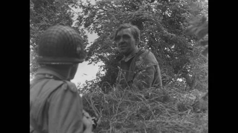 SAINT MARCOUF - 1944 - A captured German officer speaks as other soldiers Stock Footage 327735540