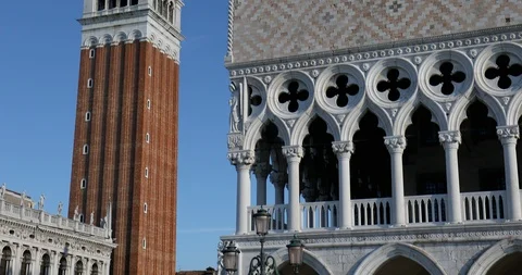 Saint Mark bell tower and Doge palace tilt view in Italy, blue sky Stock Footage 125765754