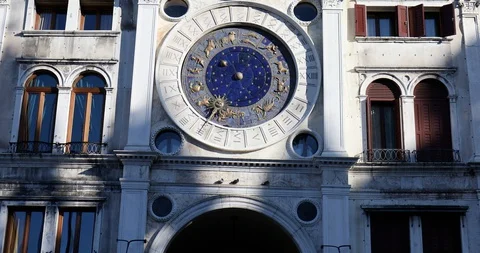 Saint Mark clock tower in Venice with gold zodiac signs, clear blue sky in Italy Stock Footage 129295239