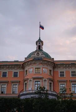 Saint Michael's Castle tower with a clock and the flag of the Russian Federation Stock Photos