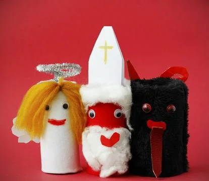 Saint Nicholas, Angel and Devil made by a child from toilet paper roll tube.. Stock Photos