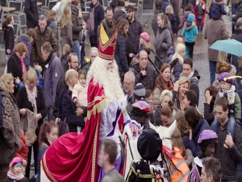 Saint Nicholas riding his white horse through Netherlands crowd of people Stock Footage 69512610