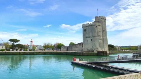Saint Nicolas tower and red lighthouse in the Old Port in La Rochelle Stock Footage 240415498
