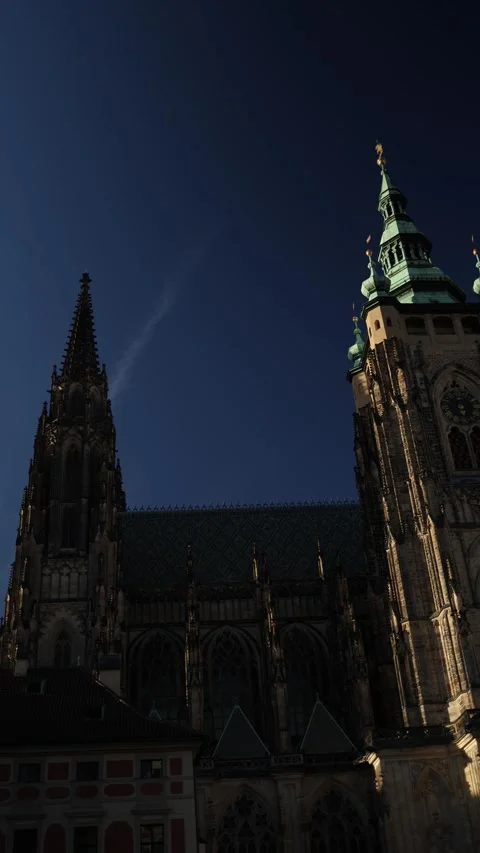 Saint Vitus Cathedral clock tower illuminated by early morning sunlight in Pragu Stock Footage 347270157