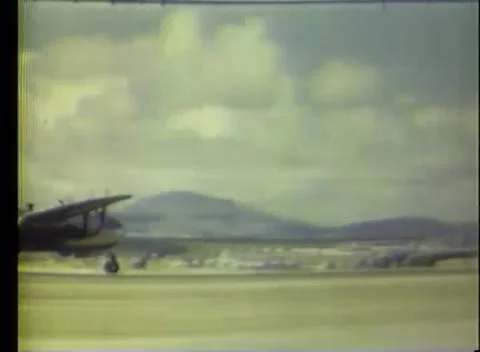 SAIPAN - 1945: Bomber operations - Parked bombers line the strip under cloud Stock Footage 343931909