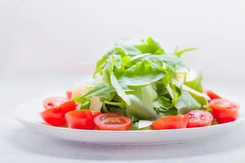 Salad with arugula, tomatoes Stock Photos