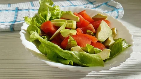 Salad with avocado tomatoes flies Video stock 87608343