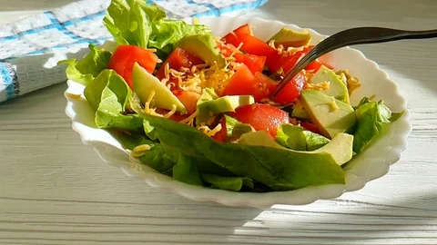 Salad avocado tomatoes slow-motion shot fork cheese Stock Footage 89253063