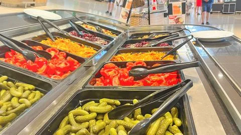 A salad bar with many different types of vegetables, including pickles Stock Photos