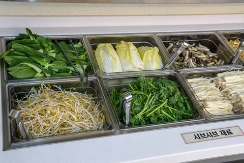 A salad bar with many different types of vegetables Stock Photos