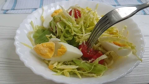 Salad cabbage tomato egg drops fork Stock Footage 87877080