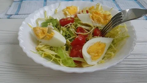 Salad cabbage tomato egg fork slow motion Stock Footage 87954258