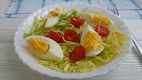 Salad cabbage tomato egg, watered with oil, slow-motion shooting Video stock 87954246