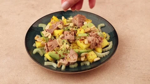Salad with canned tuna, peanuts, mango, avocado, celery, chili and sesame. Stock Footage 283104477