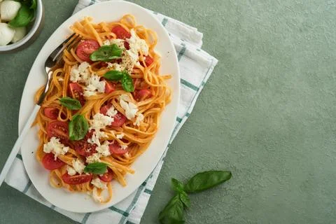 Salad caprese or pasta spaghetti broken with basil and mozzarella ala caprese Stock Photos