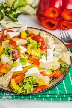 Salad with cheese and fresh vegetables. Stock Photos