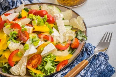 Salad with cheese and fresh vegetables. Stock Photos