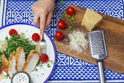 Salad with chicken (Caesar salad) with micro-greens, cherry tomatoes and Stock Photos