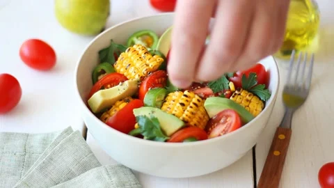 Salad with corn, avocado, tomatoes, peppers and parsley. Healthy eating. Stock Footage 201328525