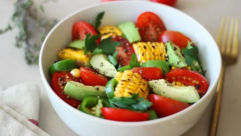 Salad with corn, avocado, tomatoes, peppers and parsley. Healthy eating. Stock Footage 201328526