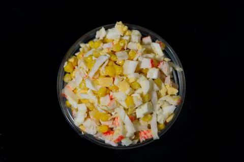 Salad of corn, eggs, cabbage and crab sticks. view from above Stock-Fotos