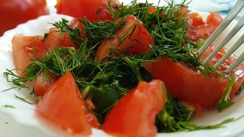 Salad cucumber tomato drops dill fork Stock Footage 88352728