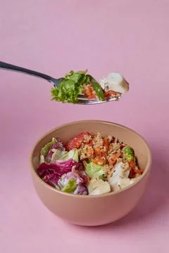 Salad in a deep dish, tomatoes, cucumbers, greens and cabbage, diet food for Stock Photos