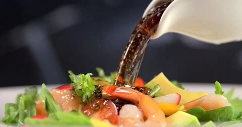 Salad dressing pouring onto fresh shrimp salad in slow motion Stock Footage 346449767