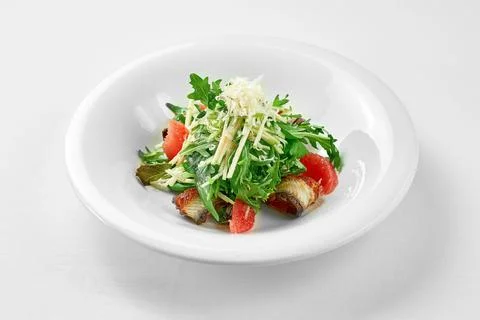 Salad with eel and grapefruit on a white plate against a white background. Cl Foto stock