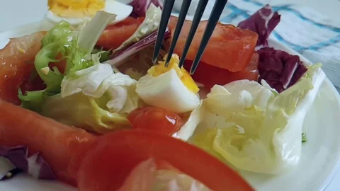 Salad egg cabbage tomatoes fork Stock Footage 89711108